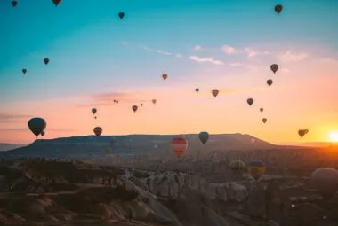 Hot air balloons flying over Cappadocia sunrise