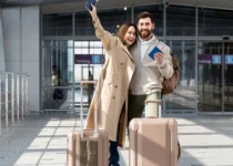 Couple with passports, visas, and suitcases at airport.